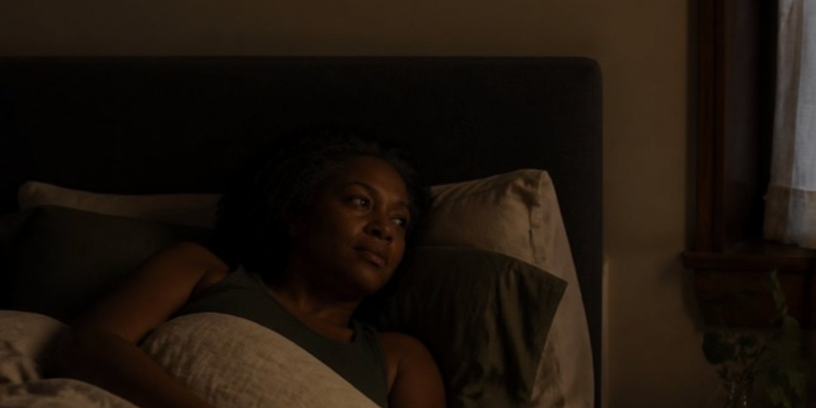 ms-why-women-wake-up-at-3am-v2 Woman lying awake in bed in dim early-morning light