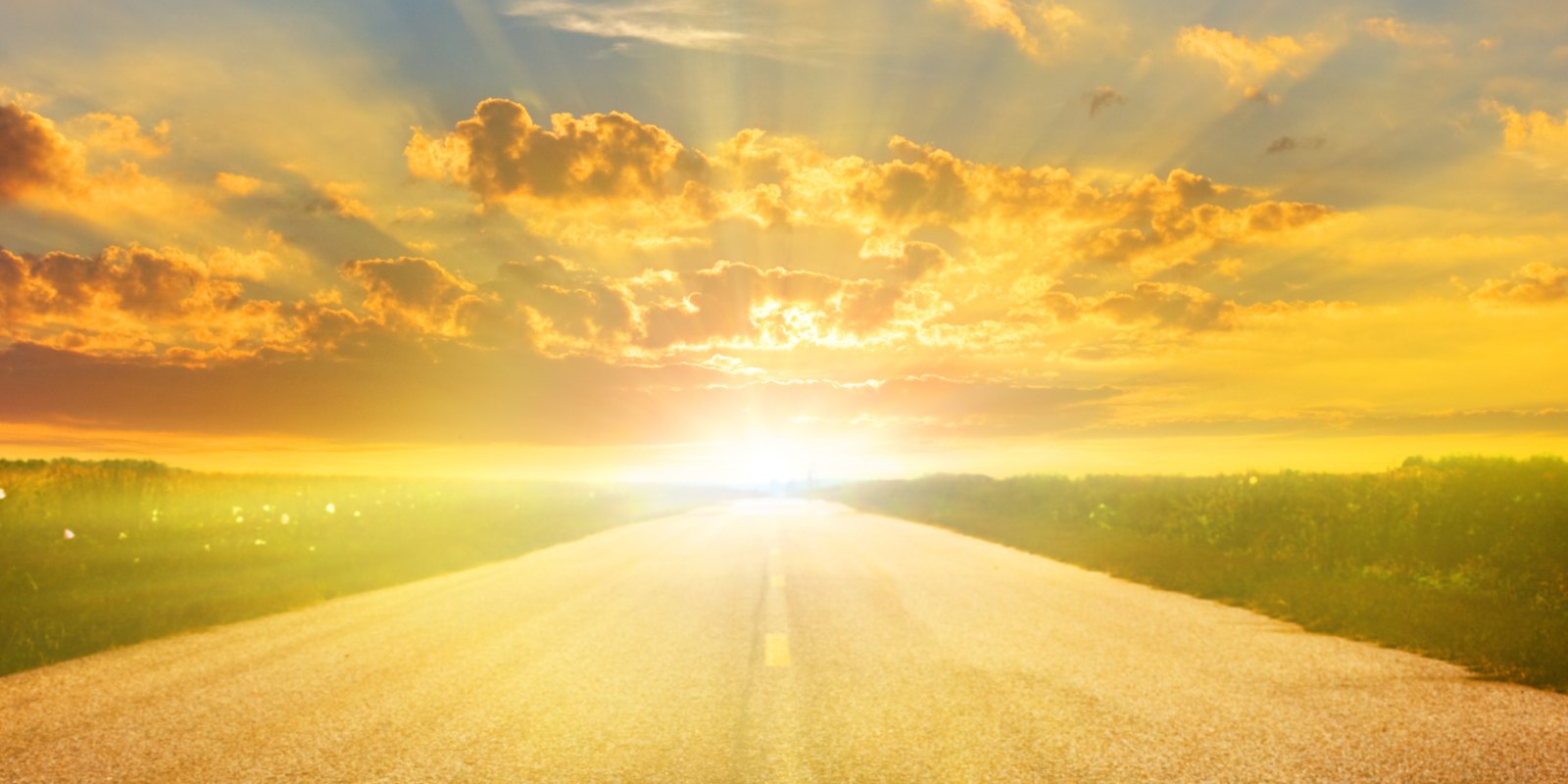 The story behind Muddy Stilettos hero An open road at sunrise under golden clouds